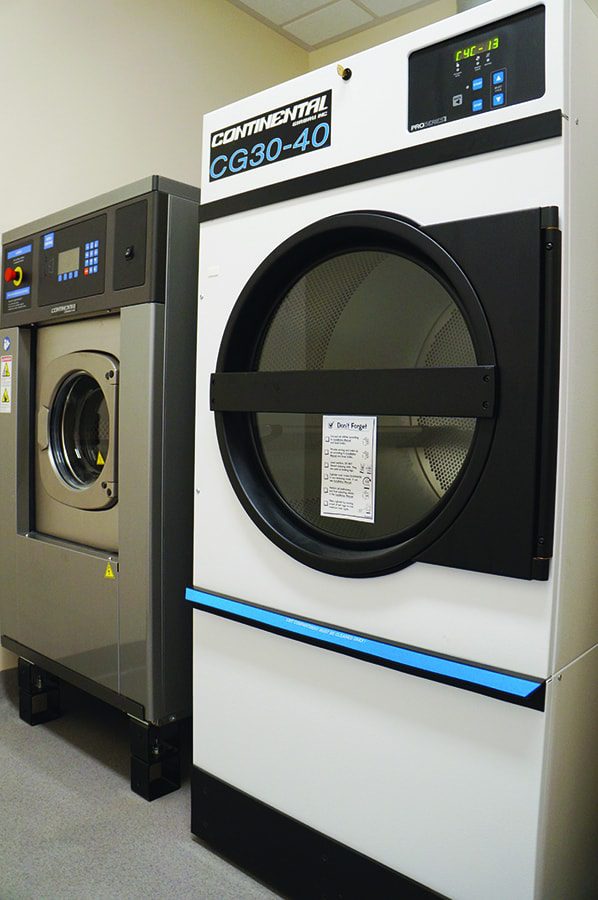 A washer and dryer in a room with white walls.